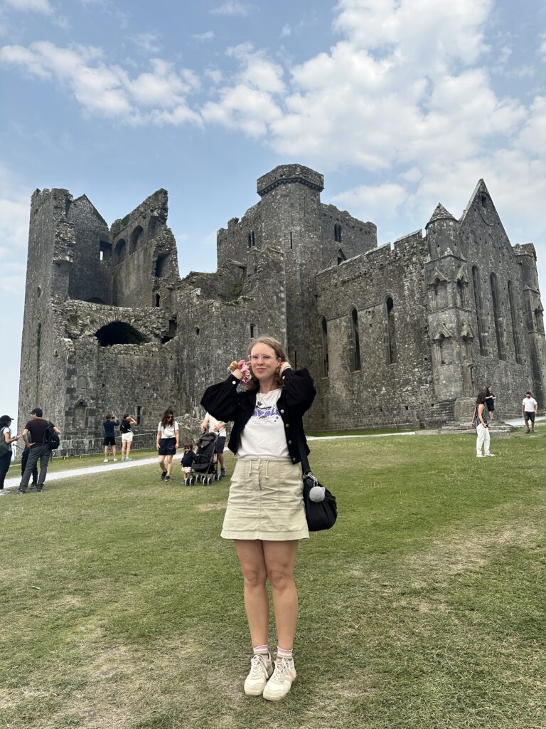 tourist at rock of cashel in ireland on a road trip