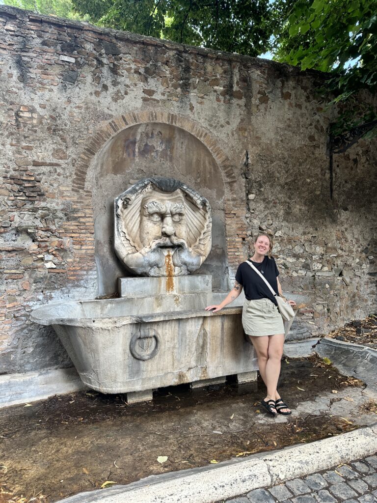 Girl poses by fountain in Aventine Hilln in Rome Italy trip using 2-day Rome itinerary