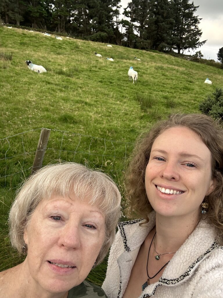 Mom and daughter take photos with sheep on the ring of Kerry