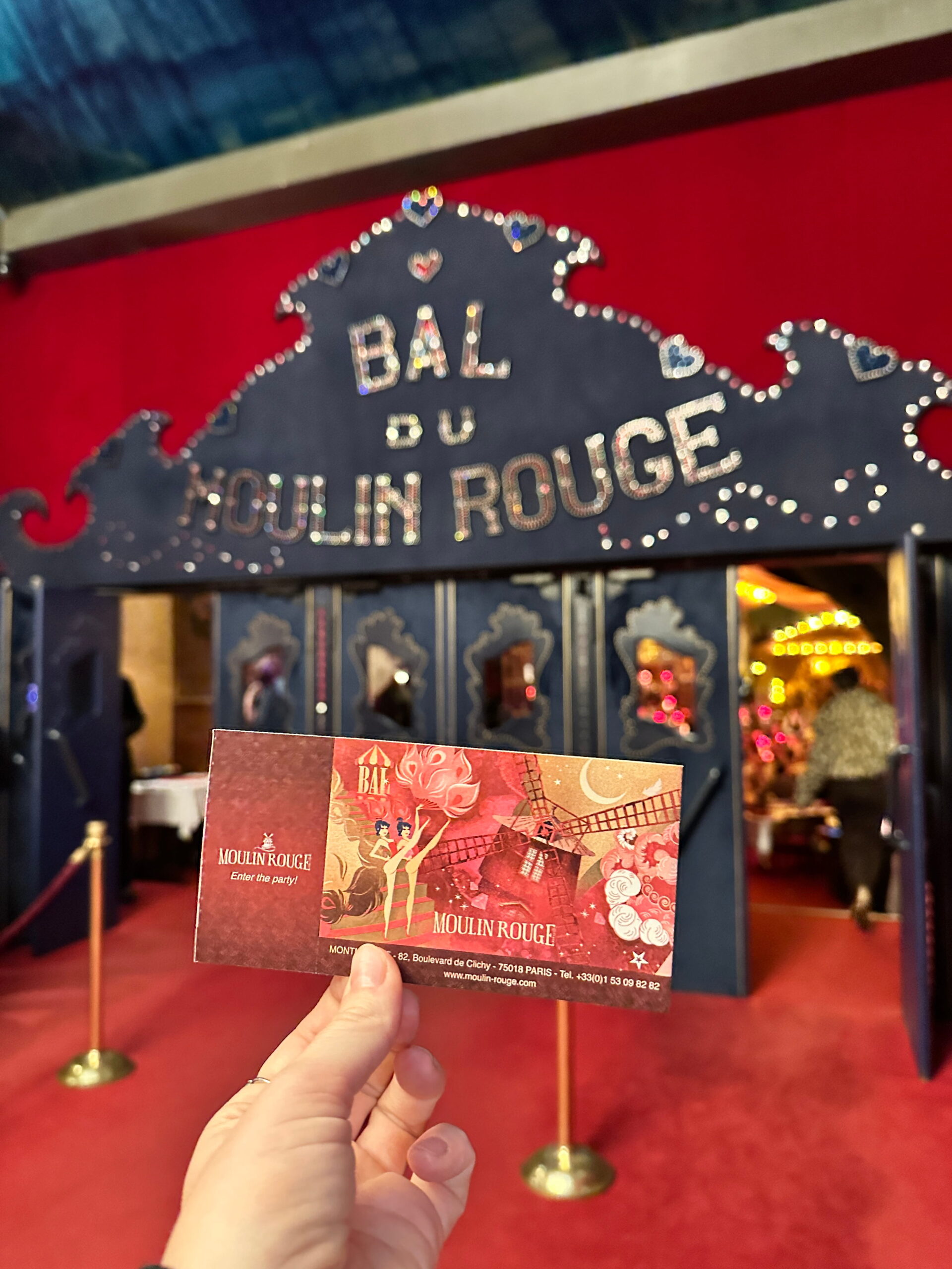 inside the moulin rouge in paris holding ticket for a klook review