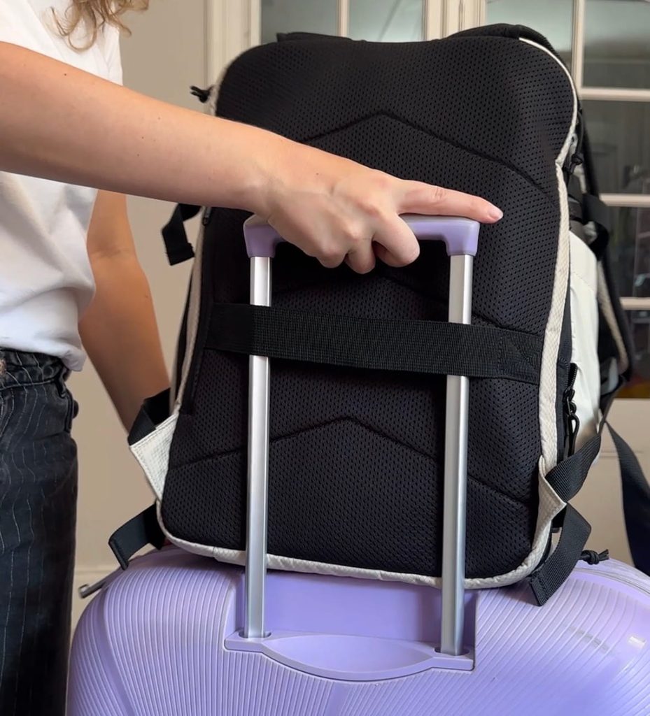 bagsmart blast 38 liter pro sitting on top of suitcase with holding strap feature