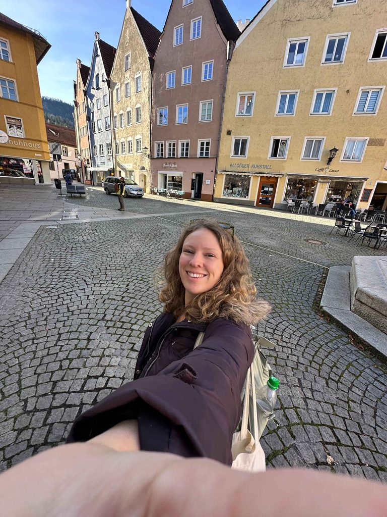 Tourist woman in the center of Füssen Germany surrounded by colorful buildings