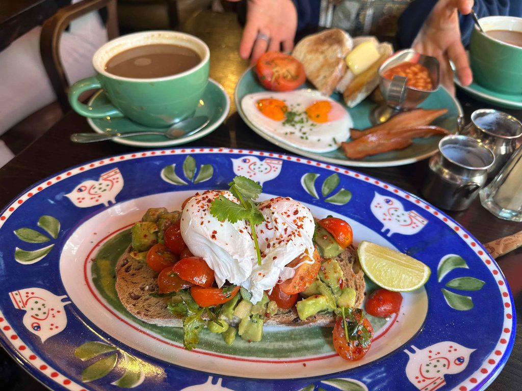 Bill's SOHO avocado on toast breakfast with English breakfast in the background best cute cafes in Central London