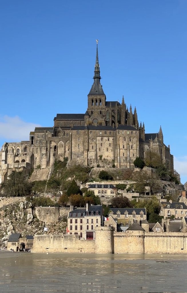 Mont Saint-Michel in Normandy France with abbey on top visit on a group day trip from paris