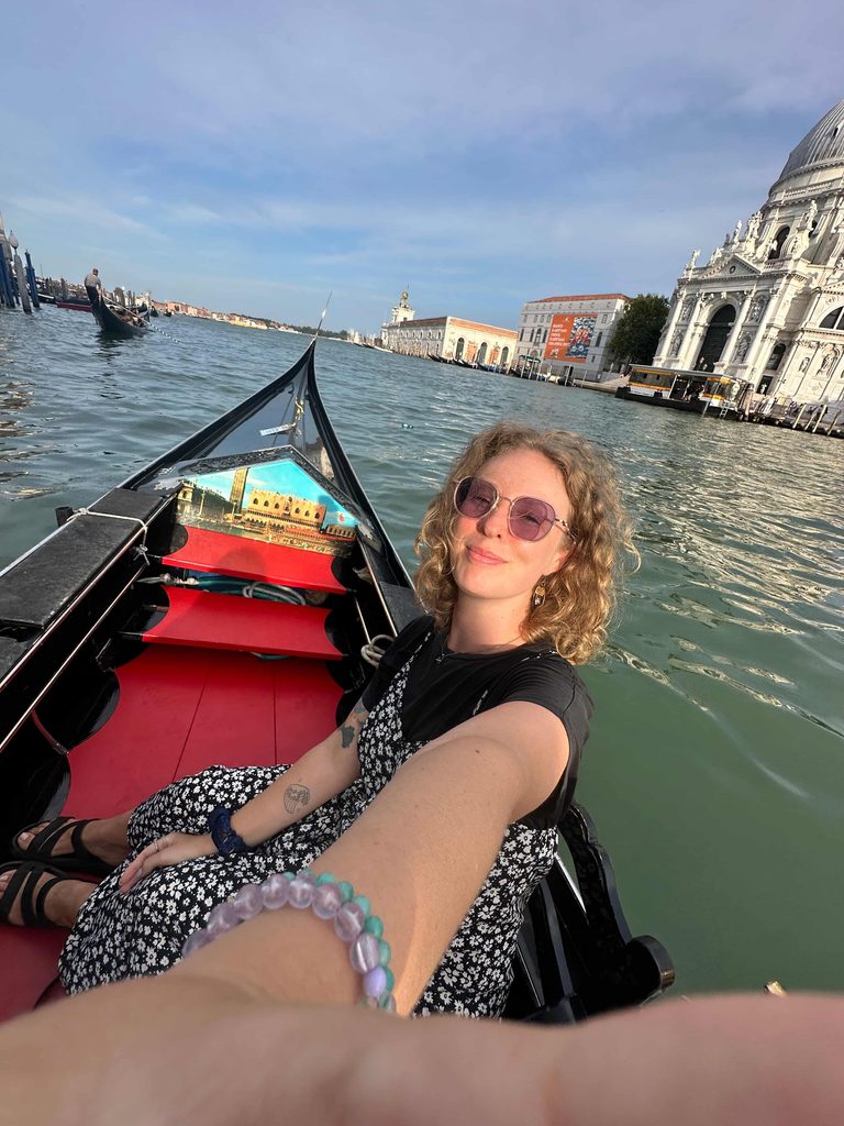 solo female traveler taking a selfie on a shared canal ride through venice on a 2 day itinerary