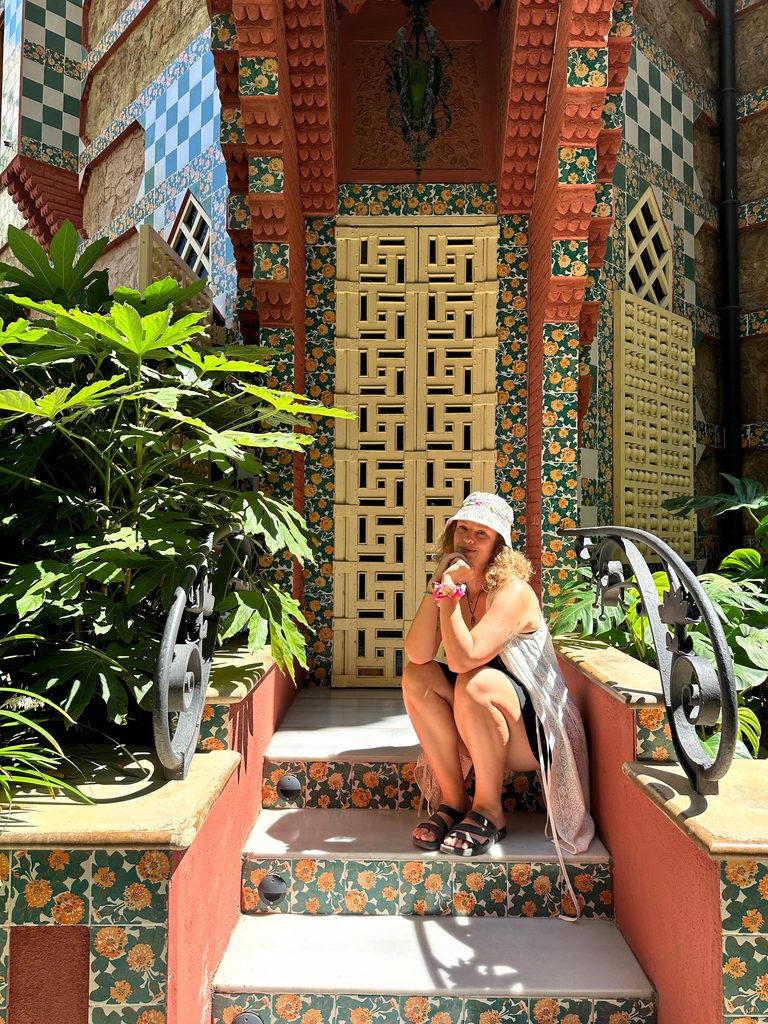sitting out front of a doorway at gaudi's casa vicens in barcelona spain