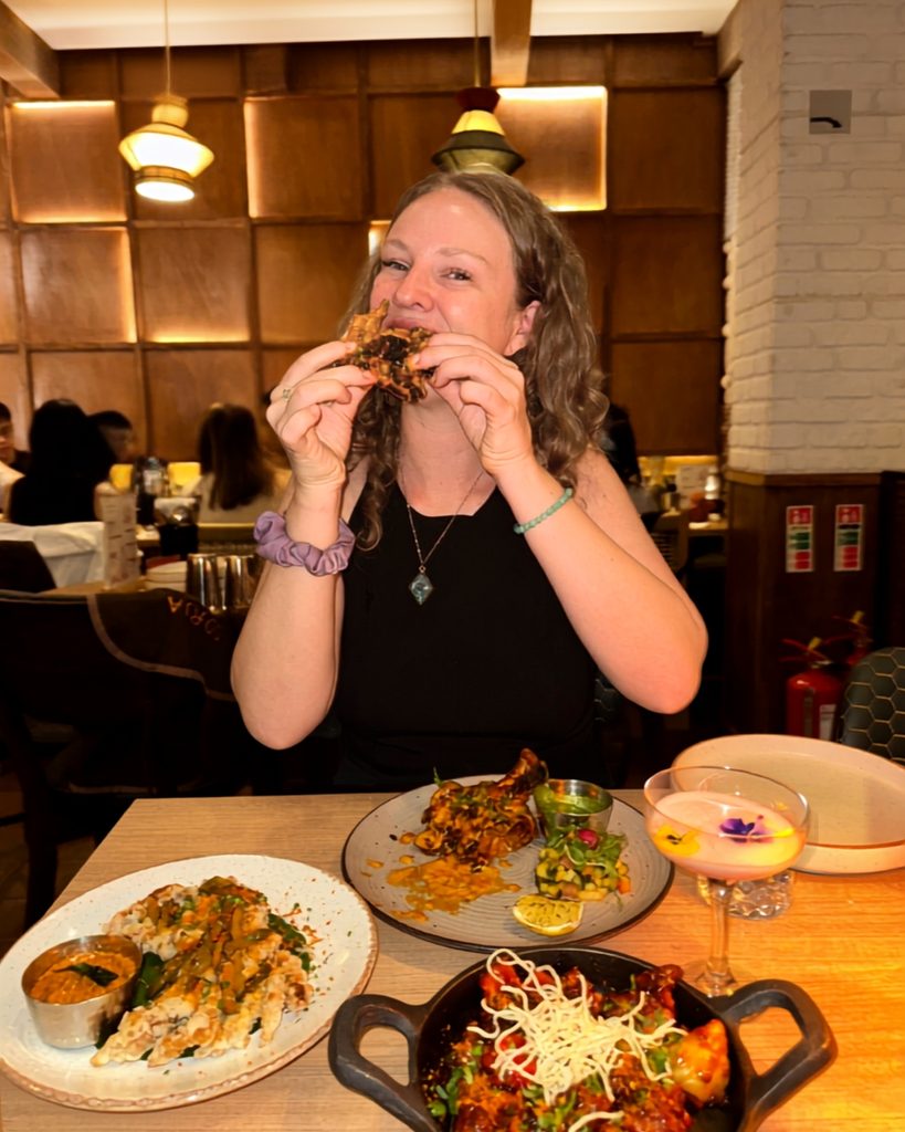 girl eats tandoori chicken at oorja best foodie indian restaurant in london