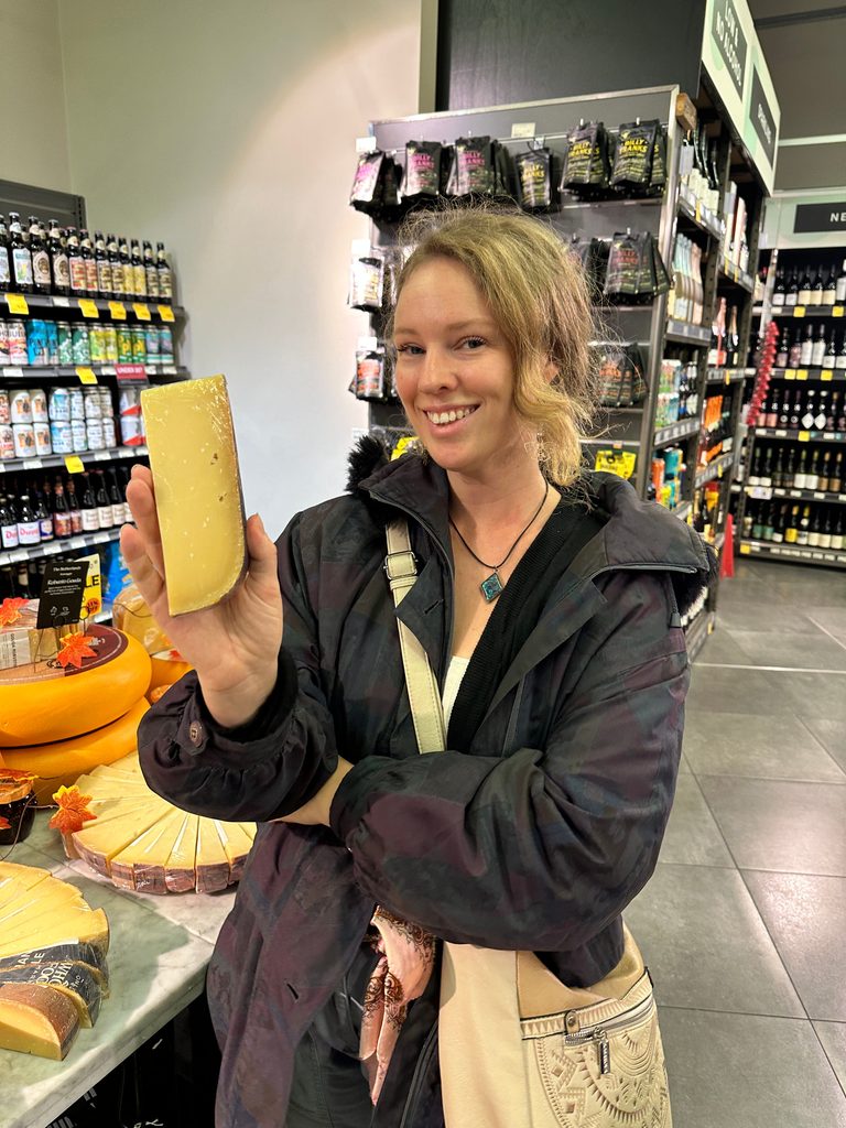 tourist holds cheese on one of the best london food tours