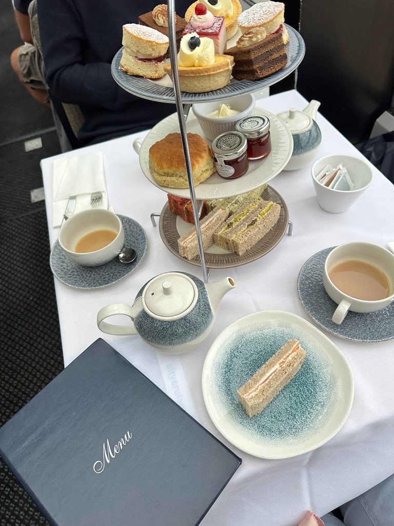 afternoon tea set on london tea cruise with cakes, sandwiches and scones