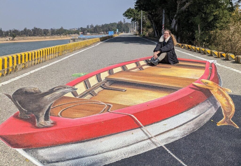 sitting on 3d artwork of an otter in shanwai jinhu lake